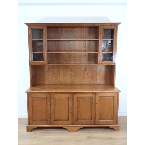 540 - A modern oak Dresser and rack fitted four fielded cupboard doors to base 6ft 2in H x 5ft 4in W