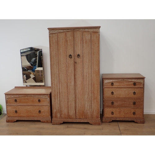 543 - A limed oak Arts and Crafts style Bedroom Suite of two door Wardrobe, Chest of drawers and Dressing ... 