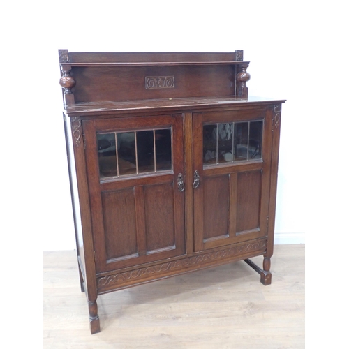 577 - An oak and glazed two door Bookcase with raised gallery back 4ft 10in H x 3ft 9in W