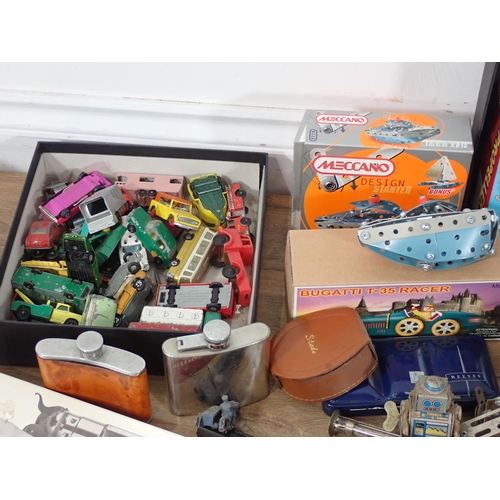 579 - A box of unboxed diecast Models, two boxed Cap Guns, tinplate Fire Engine, Meccano Boat, etc.