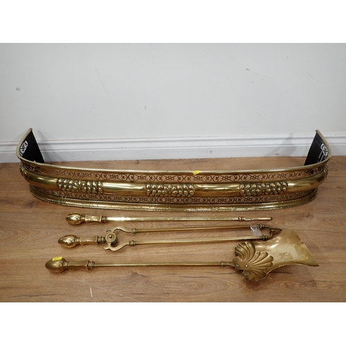 591 - An antique brass Fire Companion Set and a 19th Century pierced Fender 3ft 8in W