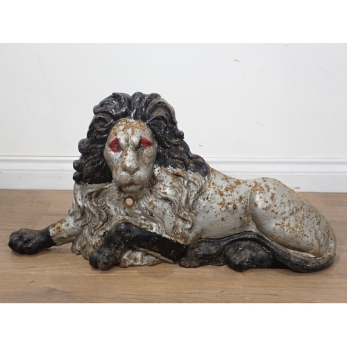 595 - A large cast iron reclining Lion 2ft 4in LW x 1ft 2in H