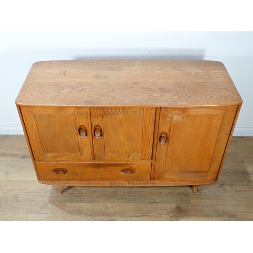 60 - An Ercol elm Sideboard fitted three cupboard doors and drawer 3ft 9in W x 2ft 8in H