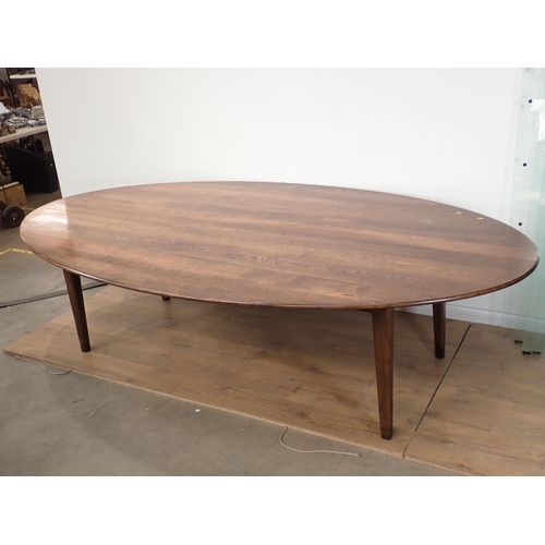 647 - A large oval oak Dining Table on square cut supports made by I. & J.L. Brown 9ft L x 5ft W x 2ft 5in... 