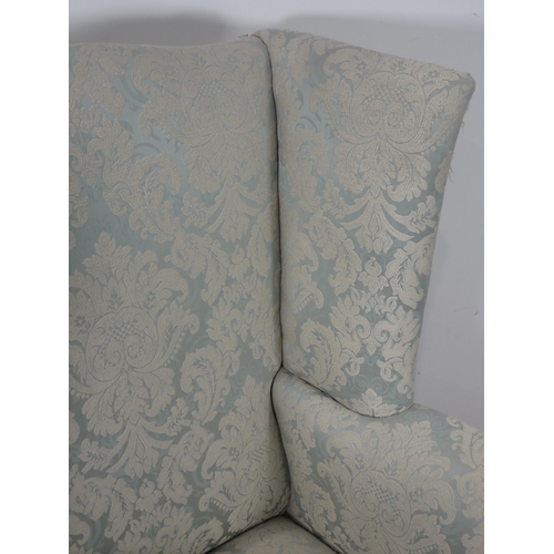 657 - A Georgian pale blue floral upholstered wingback Armchair on square cut supports