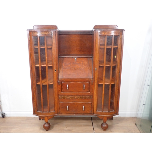 664 - An Art Deco oak Bookcase/Bureau fitted pair of bow fronted glazed doors flanking fall front above tw... 