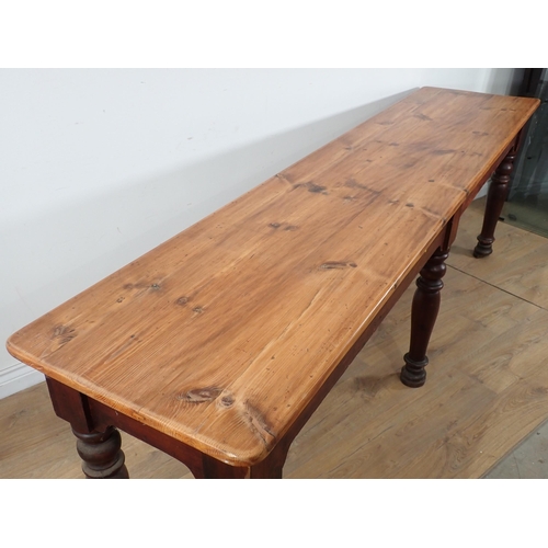 670 - A Victorian scrub top pine Serving Table on stained base with six turned supports 7ft 8in L x 2ft 6i... 