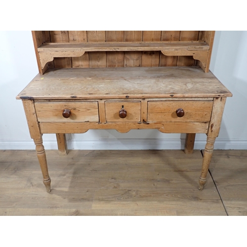 690 - A Victorian pine Dresser and Rack the base fitted three drawers mounted upon turned supports 6ft 3in... 