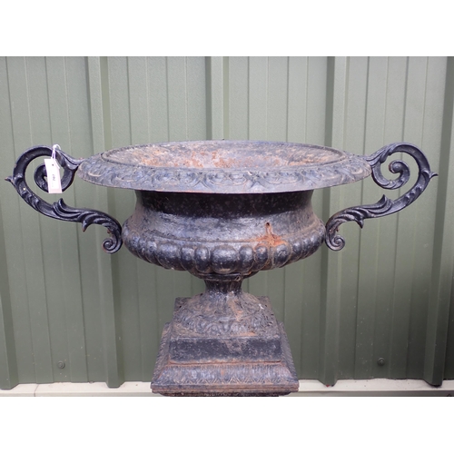 707 - A reproduction black painted cast iron two handled Urn on pedestal base decorated laurel wreaths, 2f... 