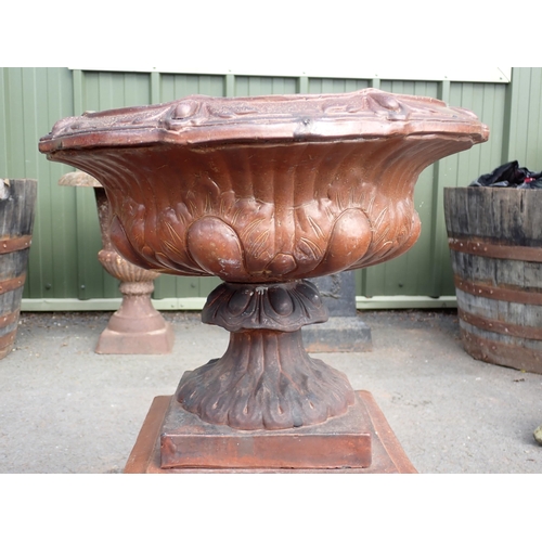 709 - A terracotta salt glazed Urn on pedestal with laurel wreath decoration 2ft 4in H