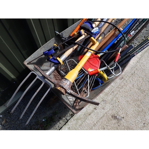 726 - A Wheelbarrow containing garden tools, pump etc