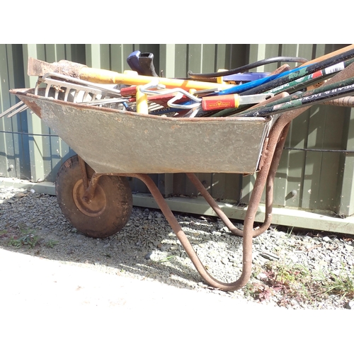 726 - A Wheelbarrow containing garden tools, pump etc