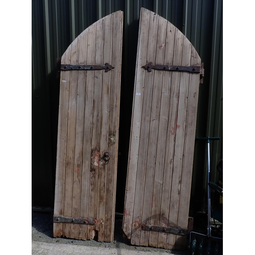 728 - A large pair of arched wooden Doors, 8ft 8in H, each door 2ft 3in W