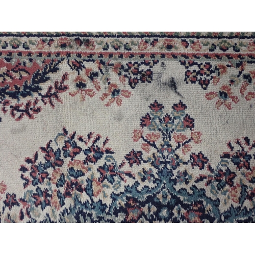 735 - A cream ground woollen Rug with central floral motif within tramline border 7ft 1in L x 5ft 4in W