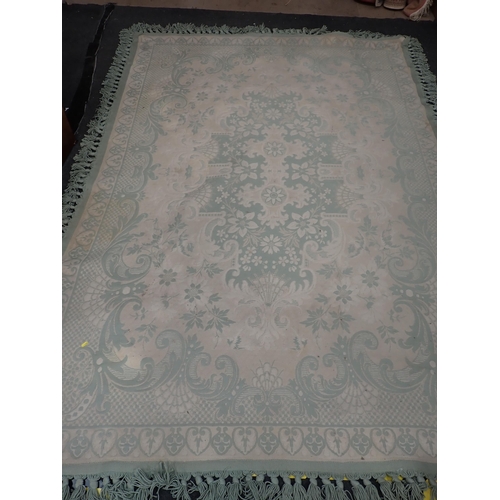 738 - A cream and pale green ground Carpet with floral design 9ft 6in L x 6ft 4in W