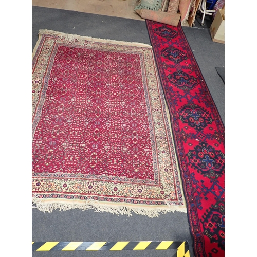 739 - A red ground Rug with intricate floral decoration within cream border 7ft L x 4ft 10in W and a red g... 