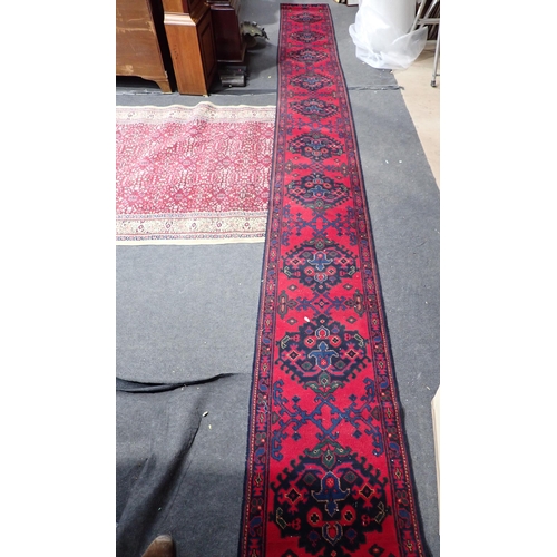 739 - A red ground Rug with intricate floral decoration within cream border 7ft L x 4ft 10in W and a red g... 