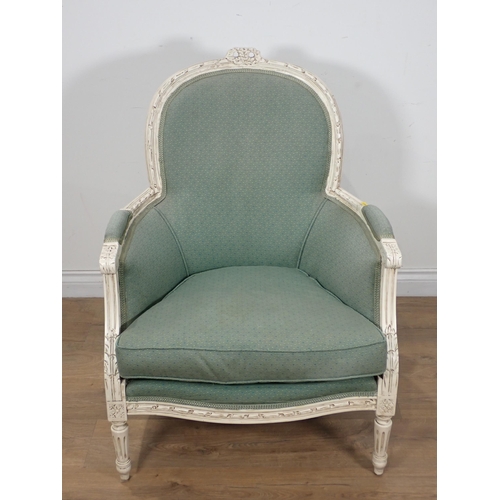 74 - A French style white and upholstered Armchair with fluted turned supports