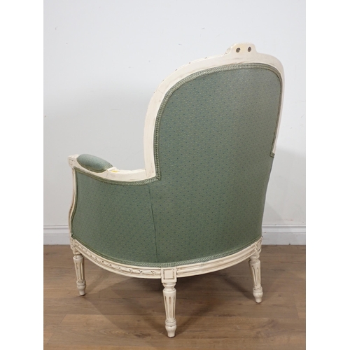 74 - A French style white and upholstered Armchair with fluted turned supports