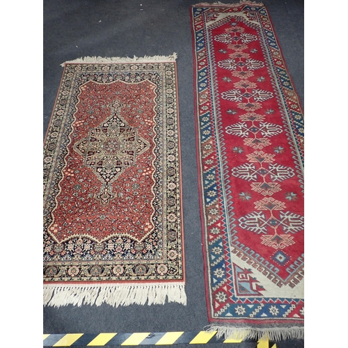 740 - A red ground Rug with beige central medallion and trailing floral design within tramline border 6ft ... 