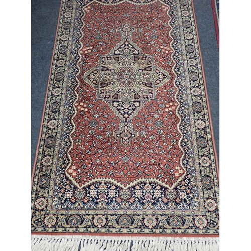 740 - A red ground Rug with beige central medallion and trailing floral design within tramline border 6ft ... 