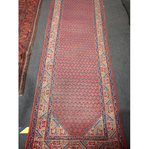 742 - A Persian red ground Rug with zig zag border 5ft 7in L x 3ft 1in W and a red ground Runner within cr... 