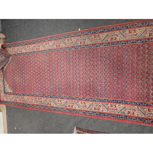 742 - A Persian red ground Rug with zig zag border 5ft 7in L x 3ft 1in W and a red ground Runner within cr... 