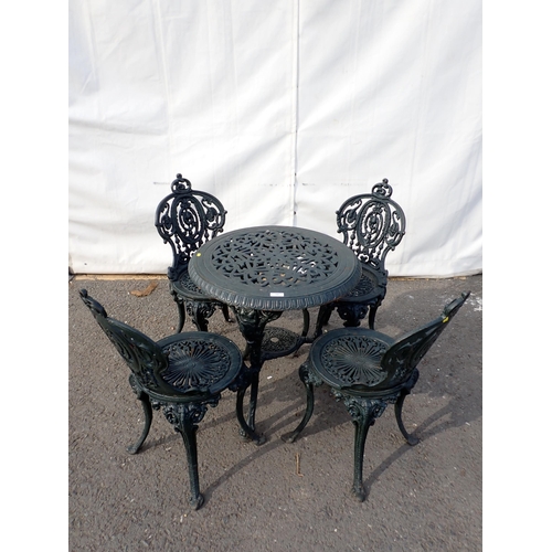 745 - A dark vintage green painted cast iron Garden Table and four Chairs