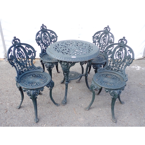 745 - A dark vintage green painted cast iron Garden Table and four Chairs