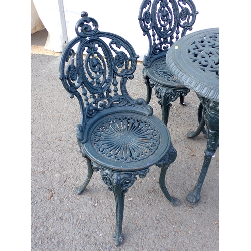 745 - A dark vintage green painted cast iron Garden Table and four Chairs