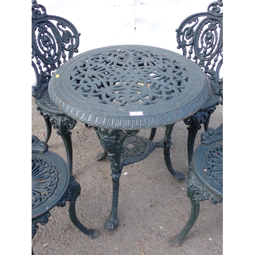 745 - A dark vintage green painted cast iron Garden Table and four Chairs