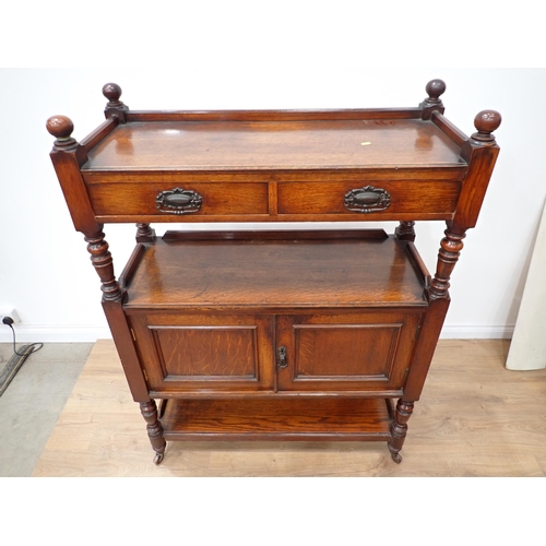 75 - An oak buffet fitted two drawers to the upper tier, with a pair of cupboard doors below with under s... 