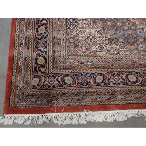 79 - A red ground woollen Carpet with dark blue central hexagon amongst floral decoration 11ft 10in L x 8... 