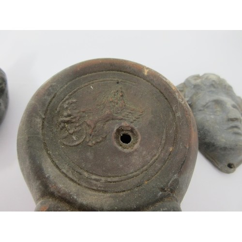 81 - An early bronze Lamp with mask design, 3in, another in terracotta, and a lead Mask Mount