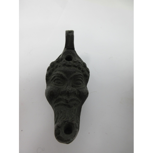 81 - An early bronze Lamp with mask design, 3in, another in terracotta, and a lead Mask Mount