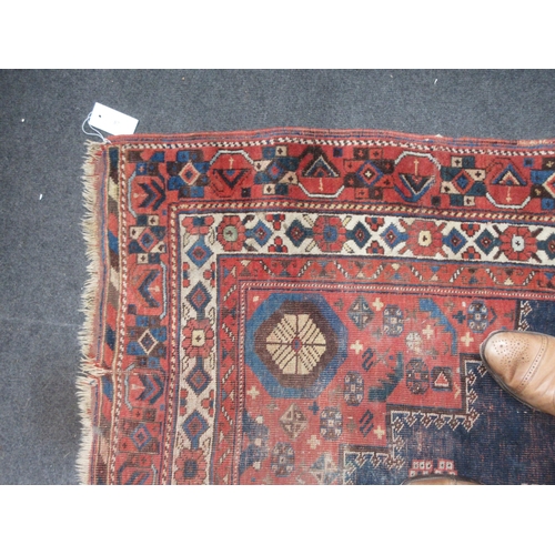 87 - An old bordered Shirvan Rug with stepped central medallion and spandrels on a red and blue ground, 5... 