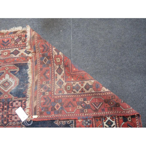 87 - An old bordered Shirvan Rug with stepped central medallion and spandrels on a red and blue ground, 5... 