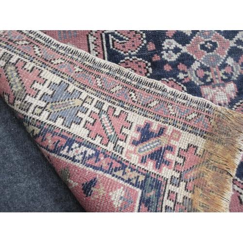 89 - An old Shirvan type Rug with double lozenge on a pink ground, 4ft 8in x 3ft 3in