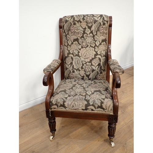 582 - A 19th Century mahogany framed open Armchair with floral upholstery mounted upon fluted front suppor... 