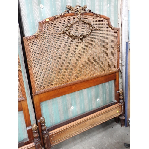 688 - A pair of French walnut framed single Beds with cane headboards and floral wreath decoration 3ft 3in... 