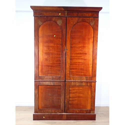 9 - A 19th Century mahogany Wardrobe fitted pair of arched panel doors on plinth base 7ft 3in H x 4ft 5i... 