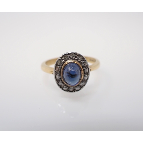 166 - A 1960's Sapphire and Diamond Cluster Ring rubover-set oval cabochon sapphire within a frame of pavé... 