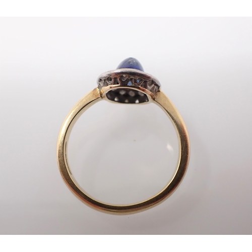 166 - A 1960's Sapphire and Diamond Cluster Ring rubover-set oval cabochon sapphire within a frame of pavé... 