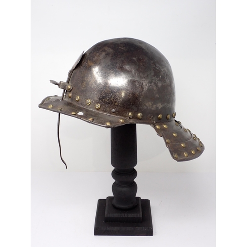 1362 - A 17th century continental cavalry helmet. Two piece pot with three lame articulated neck guard and ... 