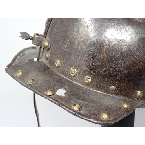 1362 - A 17th century continental cavalry helmet. Two piece pot with three lame articulated neck guard and ... 