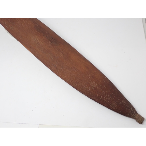 1391 - An Aboriginal wooden spear thrower. Stone carved with natural resin applied to grip and fibre bound ... 