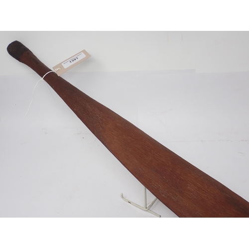 1391 - An Aboriginal wooden spear thrower. Stone carved with natural resin applied to grip and fibre bound ... 