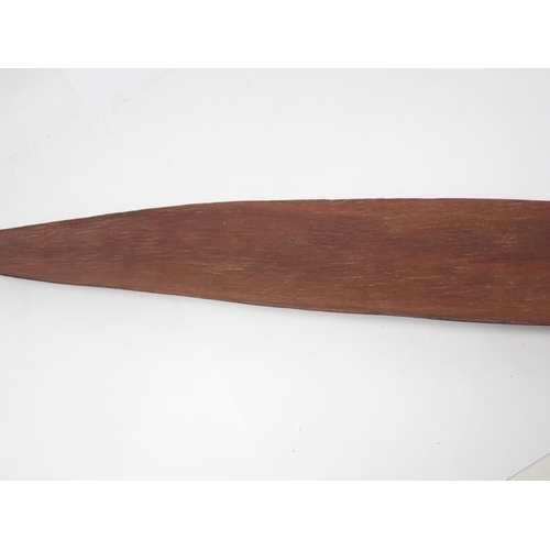 1391 - An Aboriginal wooden spear thrower. Stone carved with natural resin applied to grip and fibre bound ... 