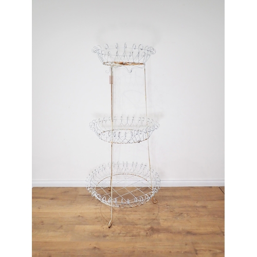 27 - A Victorian white painted wirework three tier circular Plant Stand 5ft 5in H x 2ft 7in D