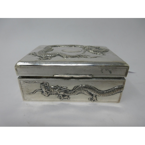 118 - A Chinese silver Cigarette Box with dragon design to lid and side, 5 x 3½in